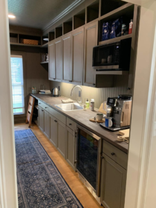 A renovated kitchenette and pantry area featuring new cabinets and sink by Heritage Design & Remodel in Raleigh, NC.