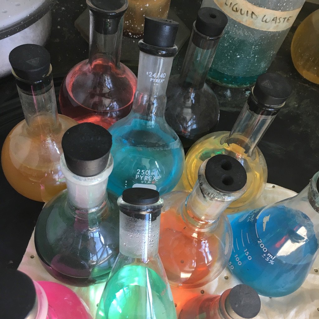 Lab flasks containing various colorful chemicals, indicating hazardous waste for MLi Environmental in South Portland, ME.