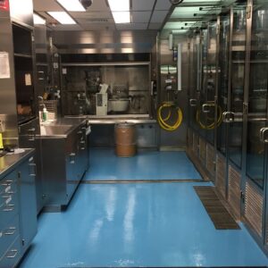 A laboratory with a bright blue epoxy floor and stainless steel equipment by Heavy Duty Floors, LLC in New Britain, CT.