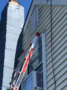 A ladder against a house for exterior repair or maintenance by AJS Contracting & Improvements LLC in Toms River, NJ.