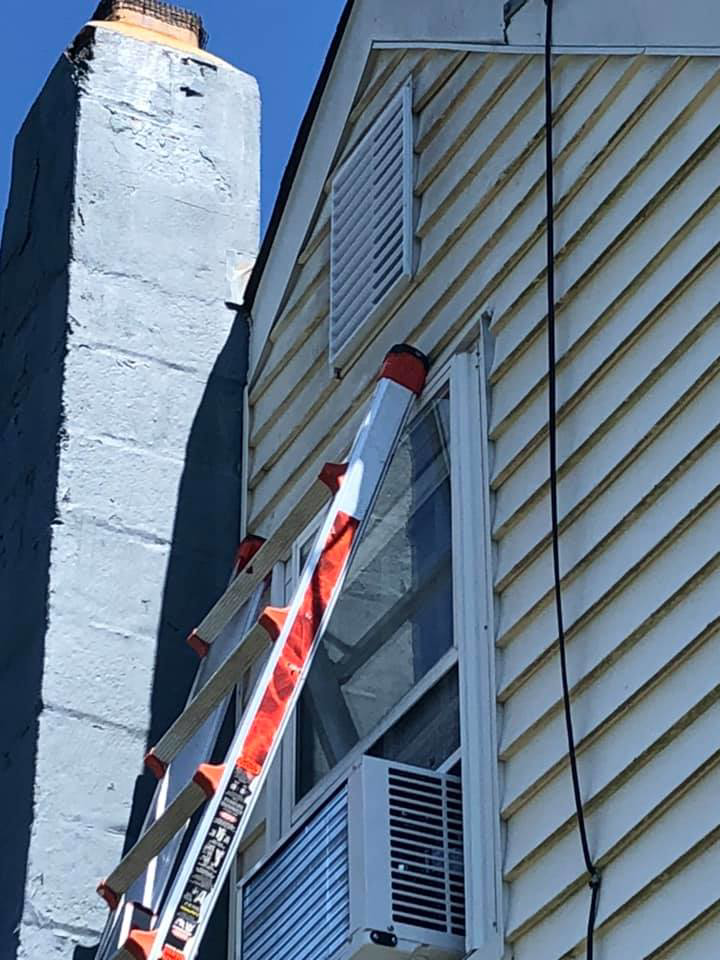 A ladder against a house for exterior repair or maintenance by AJS Contracting & Improvements LLC in Toms River, NJ.