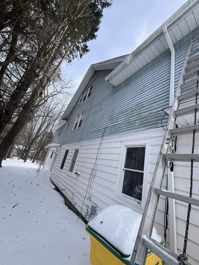 A ladder leaning against the side of a house, ready for siding or gutter work by Manny General Construction Llc in Scranton, PA.