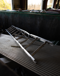 A metal ladder and other scrap items inside a large green dumpster at Bee Green Recycling in Richmond, VA