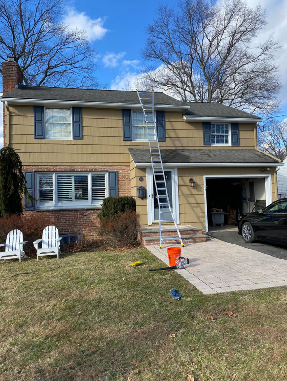 A ladder set up against a house for professional gutter cleaning or roof maintenance by DiEduardo Home Services LLC in Edison, NJ.