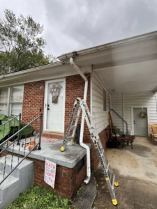 Ladders set up for gutter repair or cleaning on a brick house by Shepard Remodeling in Huntsville, AL.