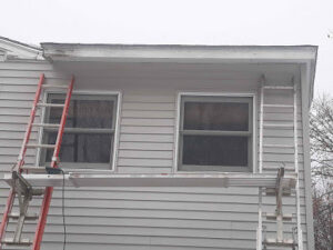 Ladders and scaffolding set up against a house exterior for handyman work by Phoenix's Cleaning Service, LLC in Rutland, VT.