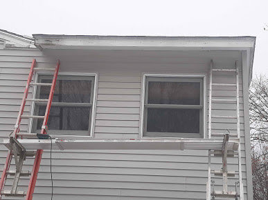 Ladders and scaffolding set up against a house exterior for handyman work by Phoenix's Cleaning Service, LLC in Rutland, VT.