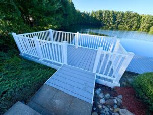 Beautiful lakeside composite deck with white railings installed by BOS HOME Exterior Services in Virginia Beach, VA
