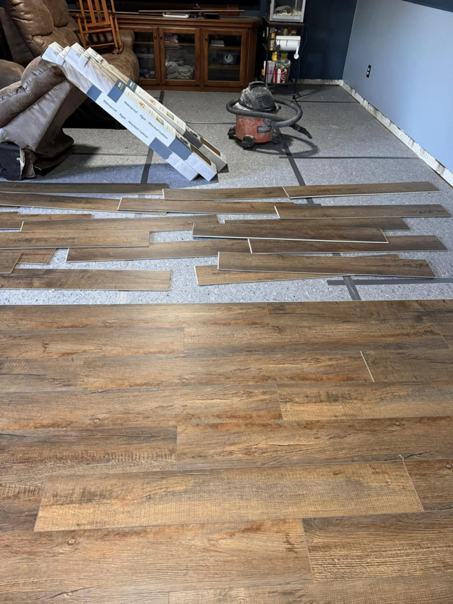 Laminate floor installation in progress with planks laid out, a service from Sanders Construction & Handyman Services, LLC in Oklahoma City, OK.