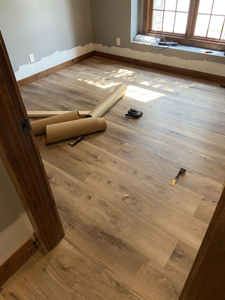 Laminate flooring installation in progress in a room, a service provided by RT Handyman LLC in Sioux Falls, SD.