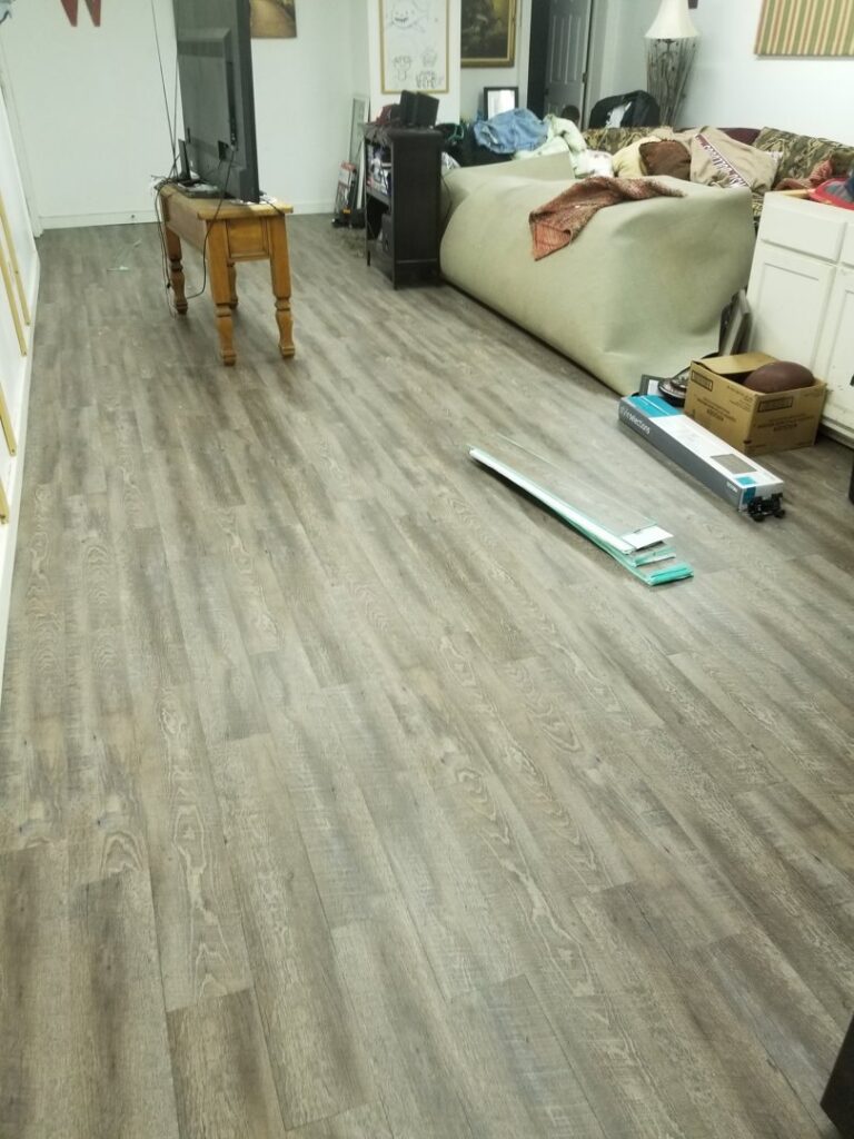 New laminate flooring being installed in an interior room, a service provided by Lee's Handyman Service LLC in Oxford, MS.