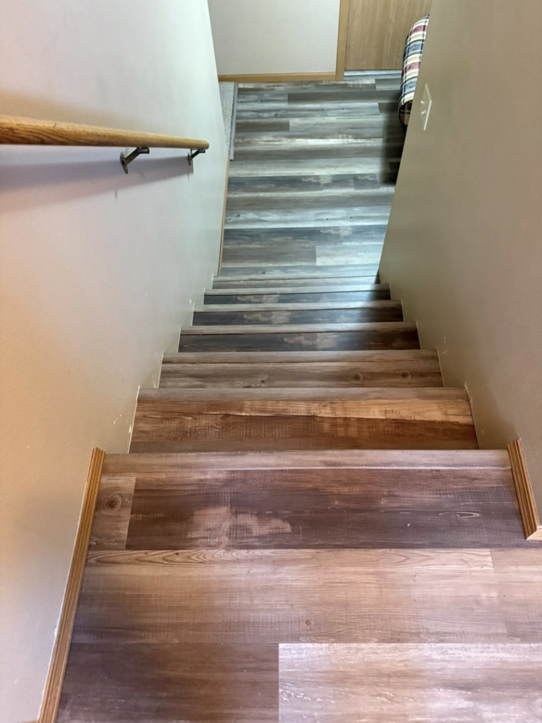 Professional laminate flooring installation on a residential staircase by Watertown Handyman in Watertown, SD.