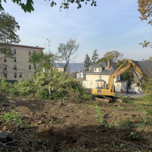 An excavator clearing land for site preparation by The J. Pilla Group Ltd. in The Bronx, NY.