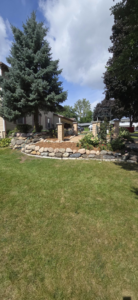 A beautifully landscaped front yard with a stone retaining wall by Schwoegler Remodeling in Madison, WI