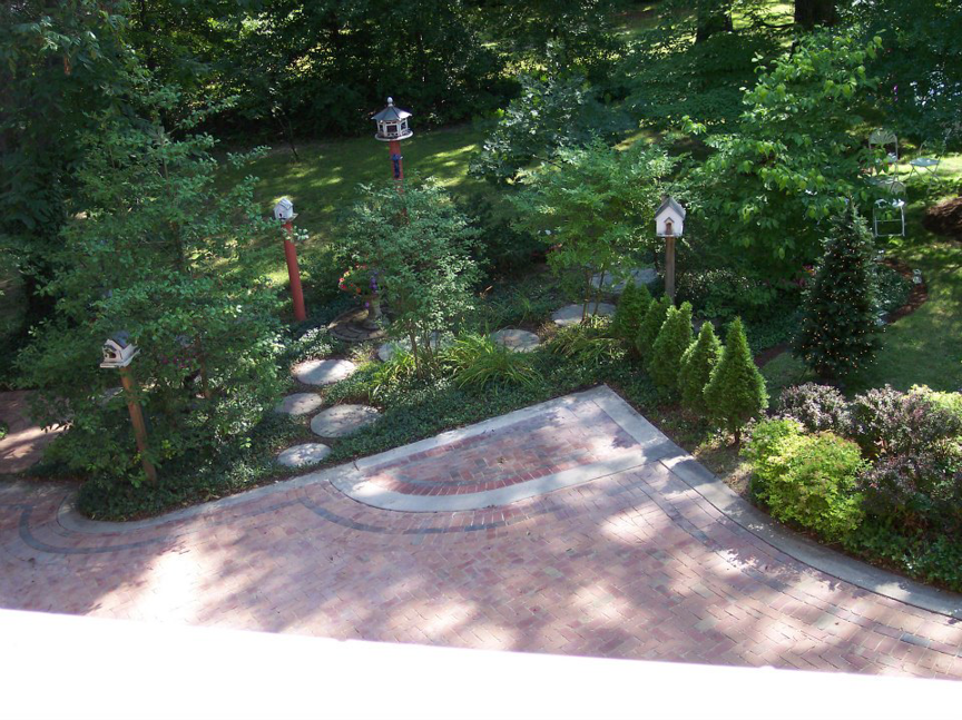 A beautifully landscaped garden with a paved path and stepping stones by Massa Paving Company in Cincinnati, OH.