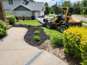 A small loader working on a residential landscaping and planting project by Tree Rows 4 U in Bismarck, ND.