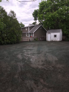 Landscaping ground preparation for a residential property by Us General, Inc. in Brockton, MA.