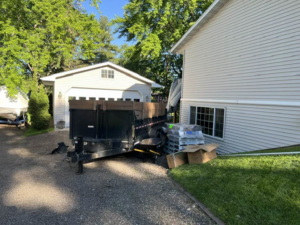 A dump trailer with landscaping materials and a wheelbarrow for a project by CRT Dump Trailer Rentals in Prior Lake, MN.