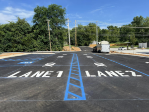 Clear LANE 1 and LANE 2 markings in a newly striped parking lot by Marine One Striping in Clarksville, TN.