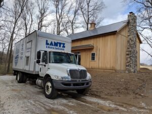 A Lantz Insulation Inc truck parked at a construction site with a new wooden building in Bird In Hand, PA.