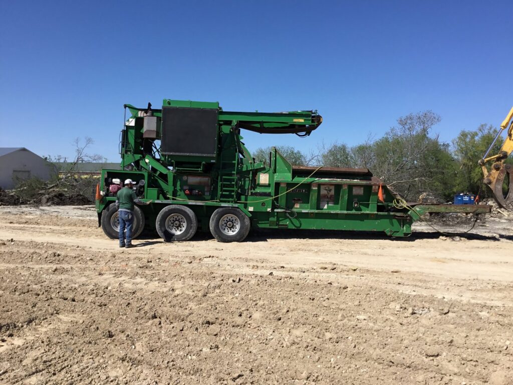 A large brush grinder on a dirt lot, used for land clearing by Parker TX Tree Service in Plano, TX.