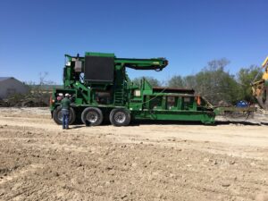 A large brush grinder on a dirt lot, used for land clearing by Parker TX Tree Service in Plano, TX.