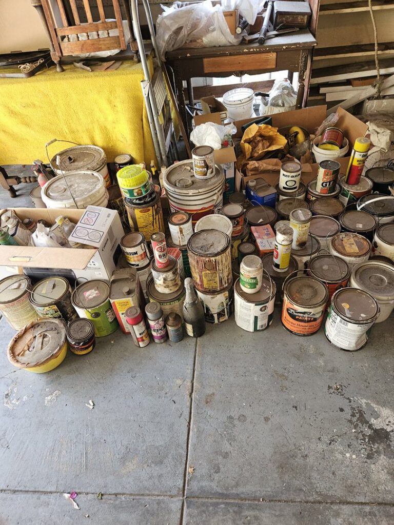 A large collection of old paint cans and hazardous materials ready for disposal by Hazawaytoday.com in El Segundo, CA