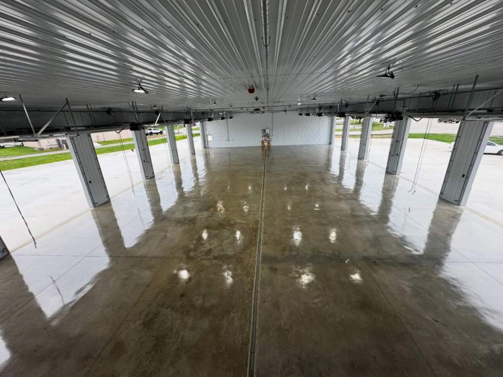 An expansive commercial space showcasing a highly reflective concrete floor coating by 812 Concrete Coatings in Evansville, IN.