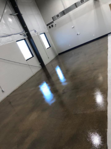 A wide view of a large commercial space with a newly polished concrete floor by Kentucky Decorative Concrete in Nicholasville, KY.