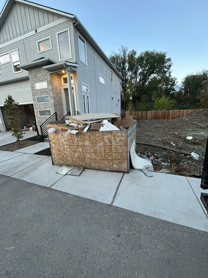 A large container overflowing with construction junk and debris, provided by Haul My Load LLC in Caldwell, ID.