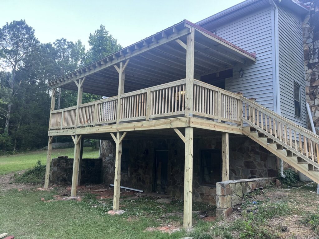A large, newly constructed covered wooden deck attached to a house, built by Hill Renovations LLC in Athens, GA