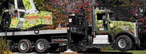 A large crane truck with a boom arm, used for tree removal and trimming by Danilo's Tree Service and Landscaping in Dallas, GA.