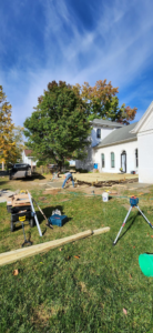 A wide view of a large deck construction project in progress next to a house, handled by Drew's Handy Construction in Charleston, IL.