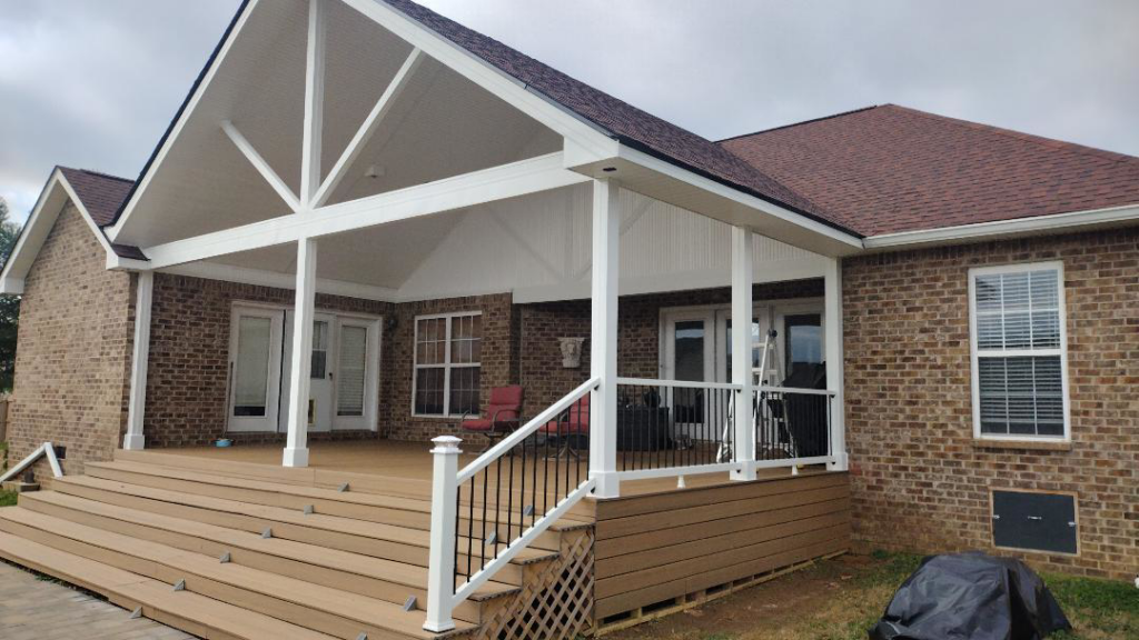 A large newly built deck and covered patio addition on a brick house by Affordable Home Improvement LLC in Pleasant View, TN.