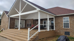 A large newly built deck and covered patio addition on a brick house by Affordable Home Improvement LLC in Pleasant View, TN.