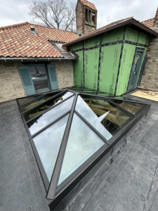 A large glass skylight or roof lantern installed on a flat roof by J & J Remodeling of Kentucky LLC in Louisville, KY.
