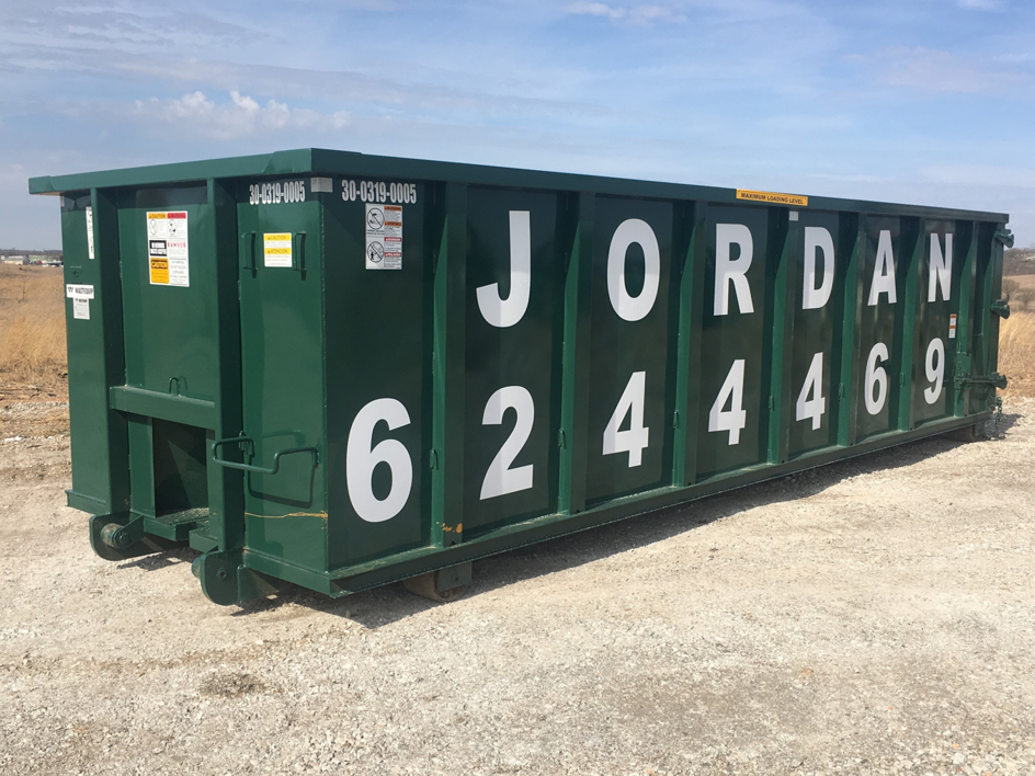 A large green roll-off dumpster branded 'JORDAN' from Jordan Disposal, LLC in Galena, KS, used for junk and waste removal.