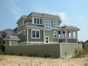 A large green house exterior showcasing completed general contracting work by FHIA Remodeling in Fort Lauderdale, FL