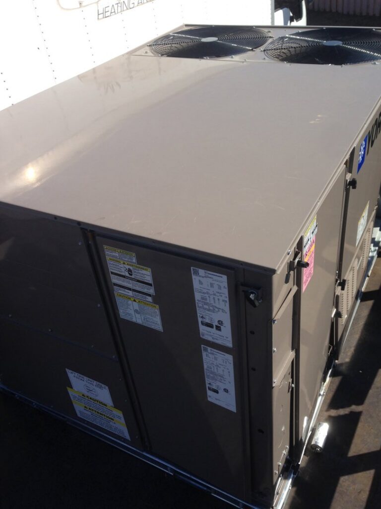 A large HVAC unit on a truck bed, likely for A/C recycling or salvage by RZR Mechanical LLC in Phoenix, AZ.