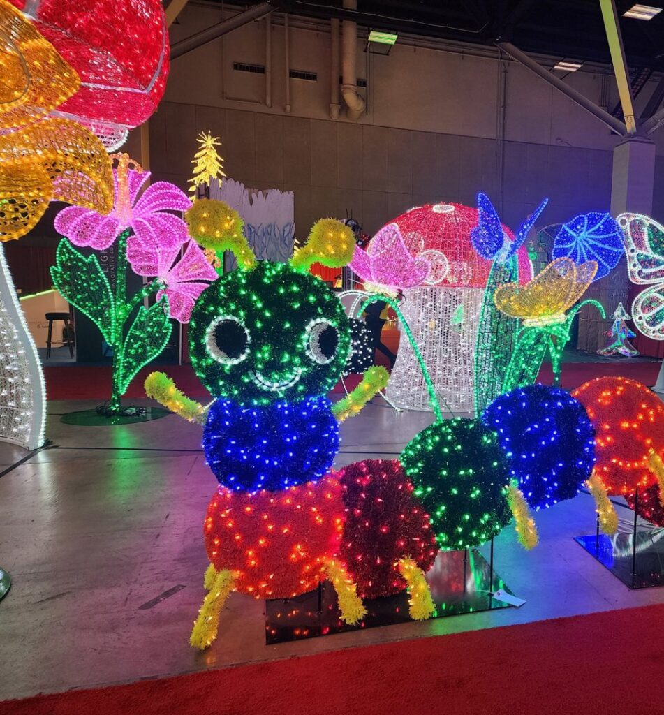 A large, colorful illuminated caterpillar and floral display installed by Chicago Christmas Lights LLC in Chicago, IL.