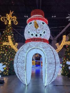 A large, illuminated snowman archway and other holiday decorations installed by Chicago Christmas Lights LLC in Chicago, IL.