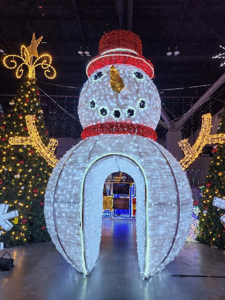 A large, illuminated snowman archway and other holiday decorations installed by Chicago Christmas Lights LLC in Chicago, IL.