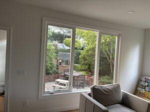 A large interior window offering a view of a backyard, installed by NC Siding and Windows in Raleigh, NC