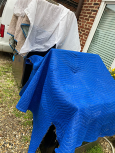 Large items covered with blue and white moving blankets, ready for hauling by K & K Haulin' in Washington D.C., DC.