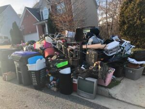 A large pile of various junk items placed curbside, awaiting removal by Dump Daddy in Buford, GA.