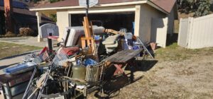 A massive pile of assorted junk and debris from a garage cleanout, ready for removal by Gabriel's Hauling & Junk Removal Services in San Diego, CA.