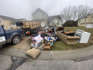 A large pile of household junk and debris awaiting pickup by Harris Family Hauling & Snow Removal LLC in Independence, MO.