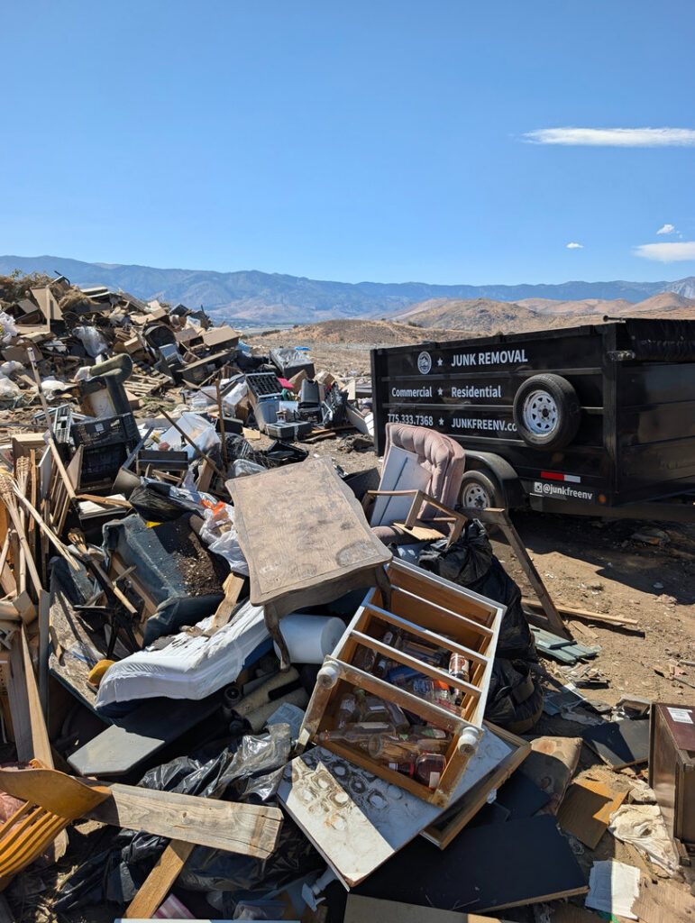 A large pile of various junk with a Junk Free Solutions trailer ready for removal in Reno, NV.