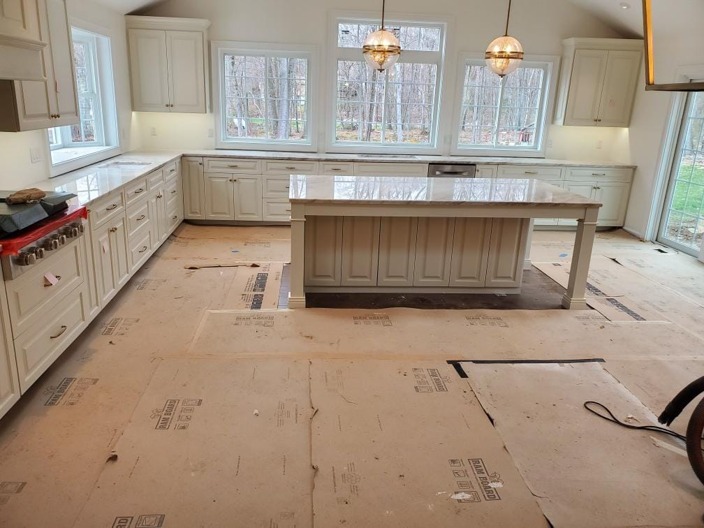 Spacious kitchen remodel with new cabinets and countertops, expertly installed by Centennial Granite in New Haven, CT.