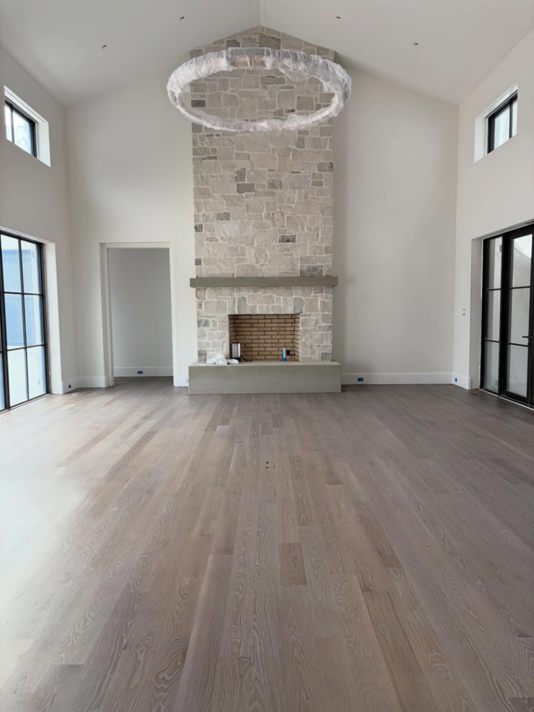 A spacious living room featuring newly installed hardwood floors by Heritage Floors of Hanover LLC in Mechanicsville, VA.